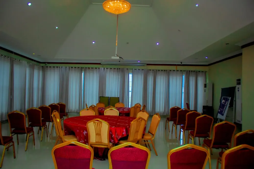 The event hall set with round tables and gold banquet chairs